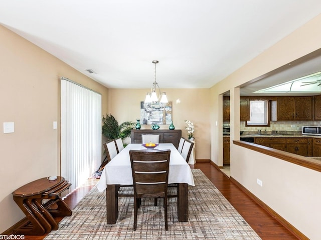 15720 Deerfield Ct Unit 2N, Orland Park, IL 60462 - dining room featuring dark wood-style floors, a chandelier, and baseboards