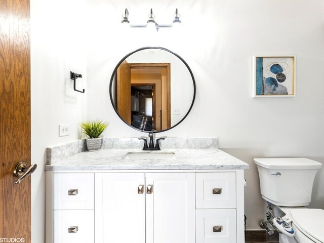 bathroom featuring toilet and vanity