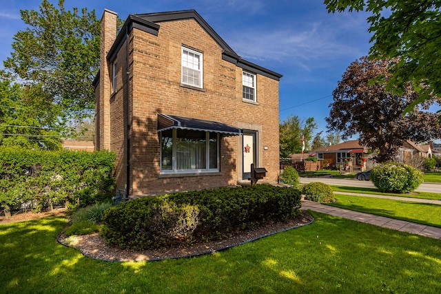 2500 S 7th Ave, North Riverside, IL 60546 - view of front of house featuring brick siding, a front lawn, and a chimney