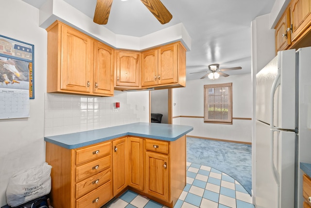 2500 S 7th Ave, North Riverside, IL 60546 - kitchen featuring a ceiling fan, freestanding refrigerator, light carpet, decorative backsplash, and a peninsula