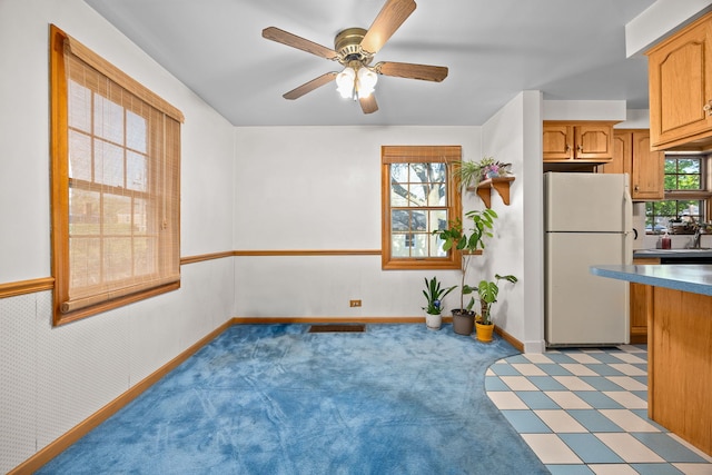 2500 S 7th Ave, North Riverside, IL 60546 - kitchen with freestanding refrigerator, ceiling fan, baseboards, light colored carpet, and brown cabinets