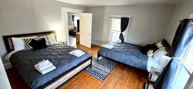 475 Laurel St, Elgin, IL 60120 - bedroom with wood finished floors, multiple windows, and baseboards