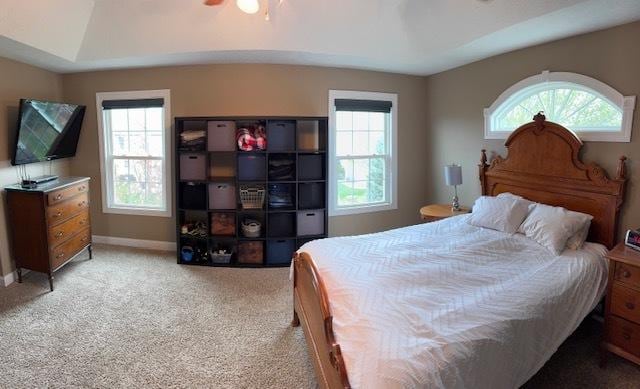 bedroom featuring a ceiling fan, light colored carpet, and baseboards