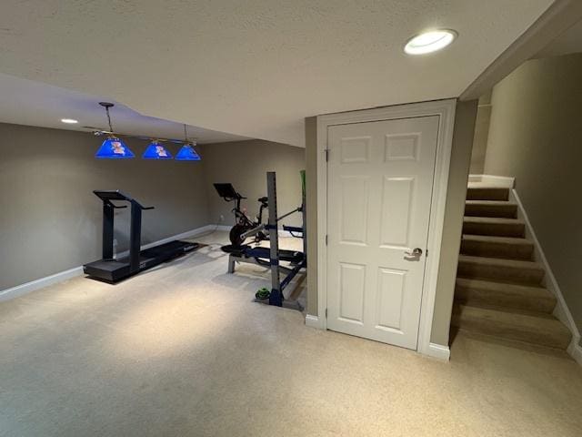 exercise room featuring baseboards, recessed lighting, and light carpet