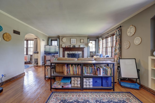 403 W 13th St, Sterling, IL 61081 - living room with wood finished floors, crown molding, visible vents, and arched walkways