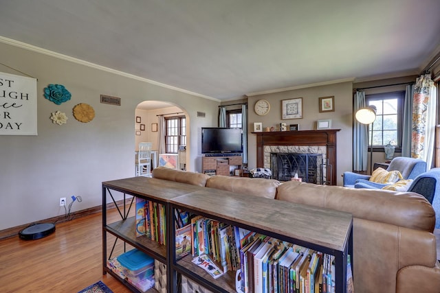 403 W 13th St, Sterling, IL 61081 - living area with arched walkways, wood finished floors, a fireplace, baseboards, and crown molding