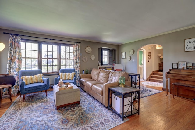 403 W 13th St, Sterling, IL 61081 - living room featuring arched walkways, a healthy amount of sunlight, ornamental molding, and wood finished floors