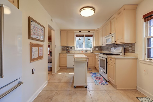 403 W 13th St, Sterling, IL 61081 - kitchen featuring tasteful backsplash, white appliances, light countertops, and light tile patterned floors