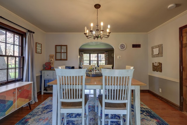 403 W 13th St, Sterling, IL 61081 - dining space with crown molding, dark wood-style floors, arched walkways, and a notable chandelier