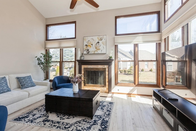 960 Heathrow Ln, Naperville, IL 60540 - living area featuring a ceiling fan, wood finished floors, a tile fireplace, and a towering ceiling