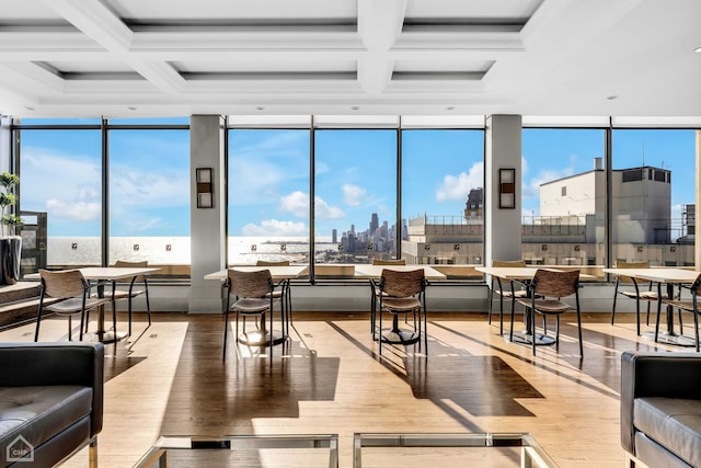 living area featuring a view of city, coffered ceiling, beam ceiling, and hardwood / wood-style floors