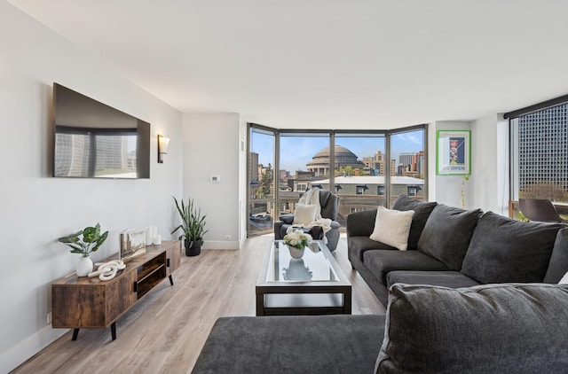 living area with baseboards and light wood-style flooring