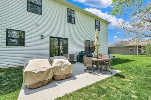 2102 Slade Ln E, Mahomet, IL 61853 - back of house featuring a lawn and a patio