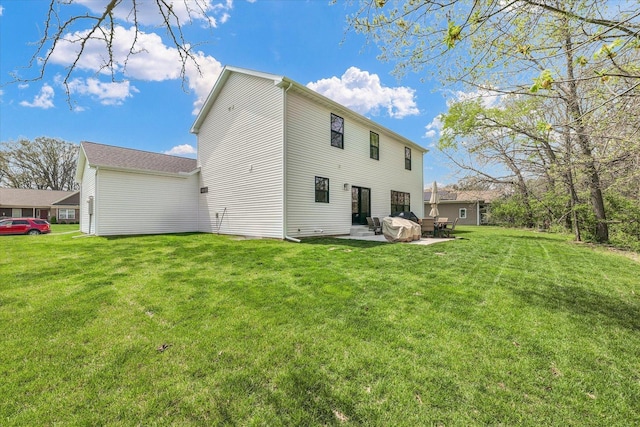 2102 Slade Ln E, Mahomet, IL 61853 - back of property featuring a lawn and a patio area