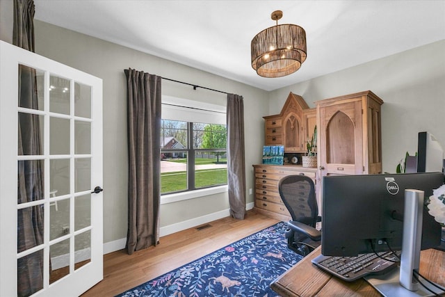2102 Slade Ln E, Mahomet, IL 61853 - office area with an inviting chandelier, baseboards, wood finished floors, and visible vents