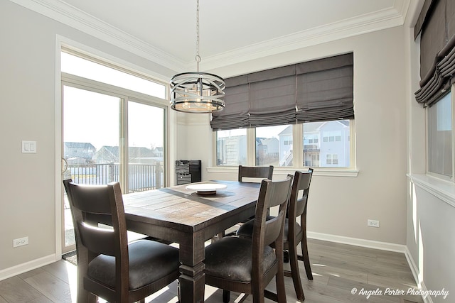 dining area featuring baseboards, an inviting chandelier, and light wood finished floors