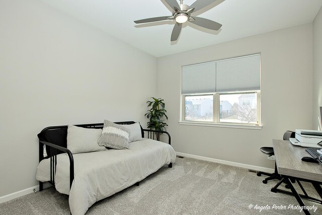 carpeted bedroom featuring ceiling fan and baseboards