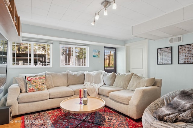 living room with track lighting and wood finished floors