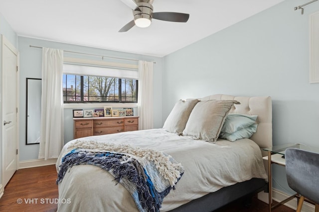 bedroom with wood finished floors, baseboards, and ceiling fan