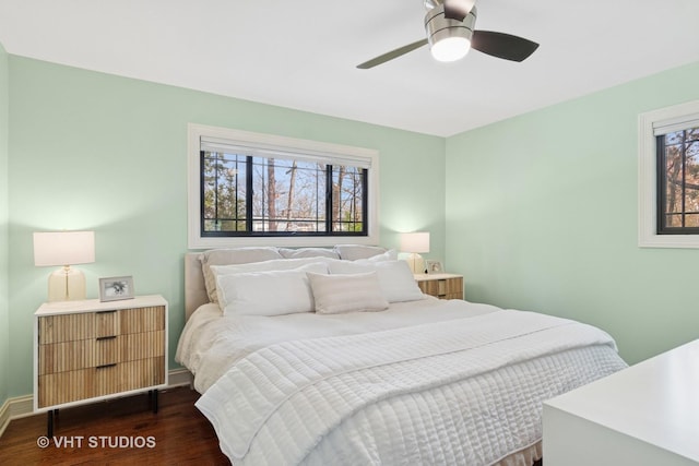 bedroom with wood finished floors, baseboards, and a ceiling fan