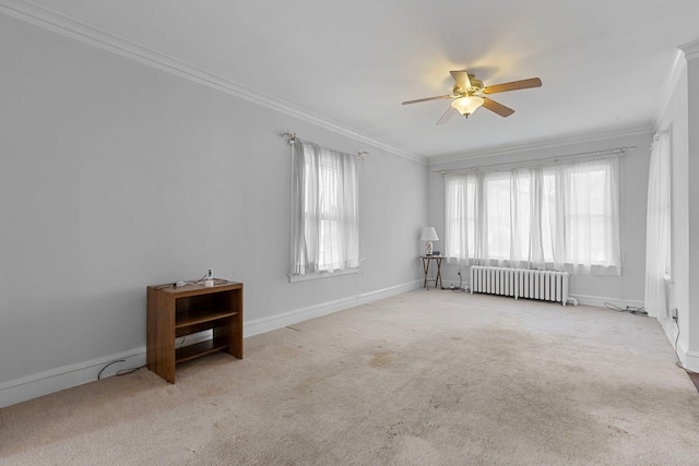 825 Saint John St, Elgin, IL 60120 - empty room featuring radiator heating unit, crown molding, a ceiling fan, and carpet floors