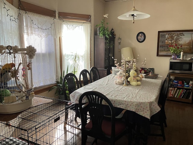 dining space with wood finished floors
