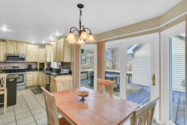 dining room featuring recessed lighting, light tile patterned floors, a notable chandelier, and a toaster