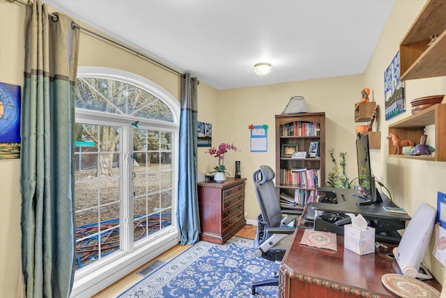 office with visible vents and wood finished floors