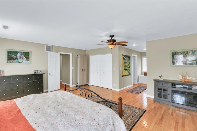 bedroom featuring baseboards, ceiling fan, hardwood / wood-style floors, and visible vents