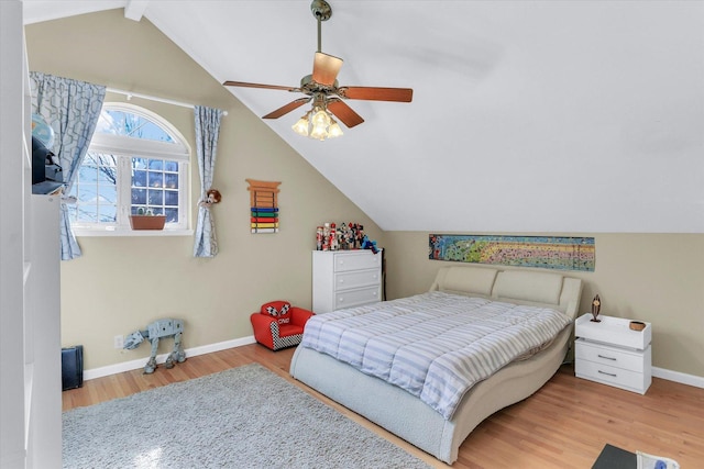 bedroom featuring baseboards, ceiling fan, lofted ceiling, and wood finished floors