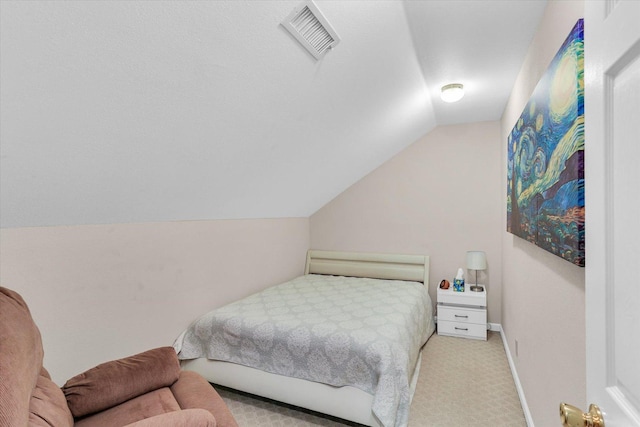 bedroom with carpet floors, vaulted ceiling, and visible vents