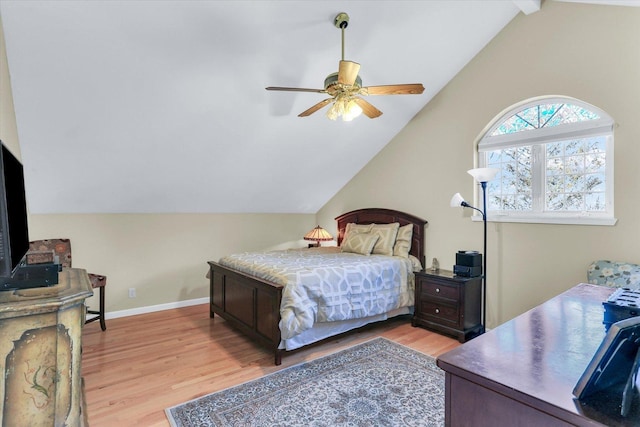 bedroom featuring baseboards, ceiling fan, wood finished floors, and lofted ceiling