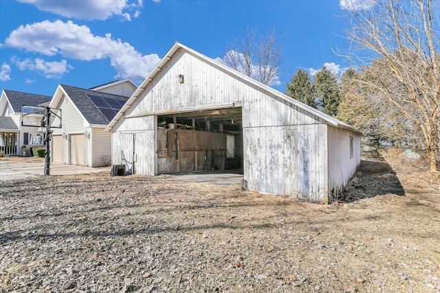 view of outbuilding with central AC, solar panels, and an outdoor structure