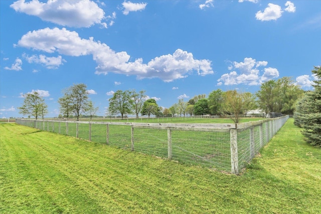 view of yard featuring fence and a rural view