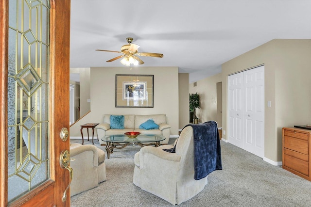 living room with baseboards, carpet flooring, ceiling fan, and visible vents