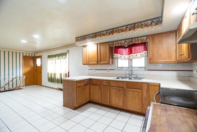17246 Bernadine St, Lansing, IL 60438 - kitchen featuring light countertops, brown cabinets, electric range oven, a sink, and a peninsula