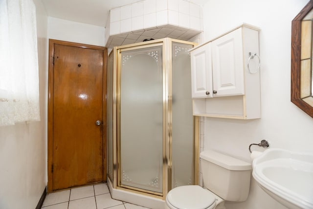 17246 Bernadine St, Lansing, IL 60438 - bathroom with tile patterned floors, toilet, a shower stall, and a sink
