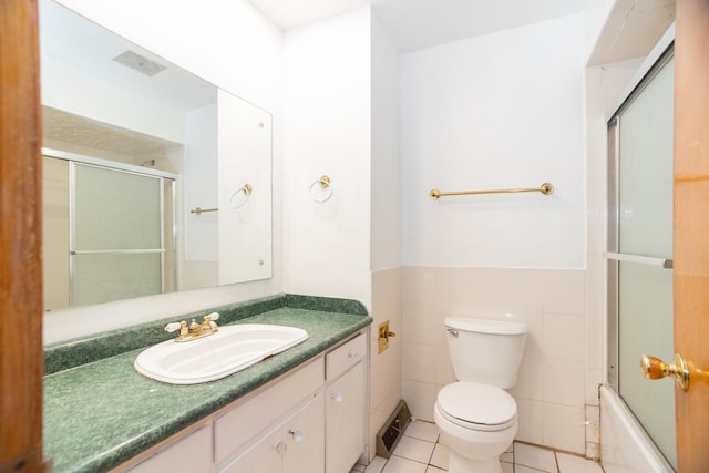 17246 Bernadine St, Lansing, IL 60438 - bathroom with toilet, tile walls, tile patterned floors, vanity, and wainscoting