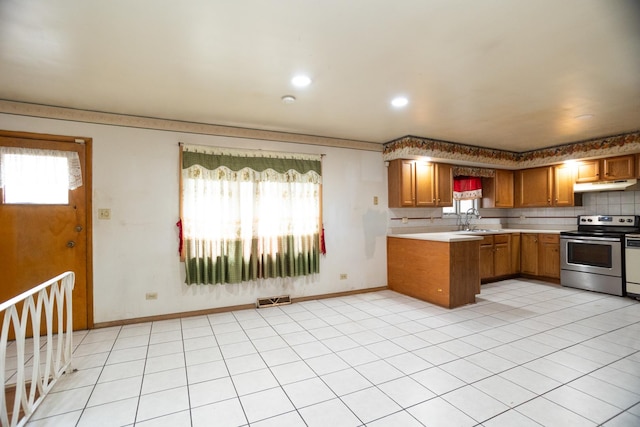 17246 Bernadine St, Lansing, IL 60438 - kitchen featuring under cabinet range hood, light countertops, stainless steel electric range, a sink, and visible vents