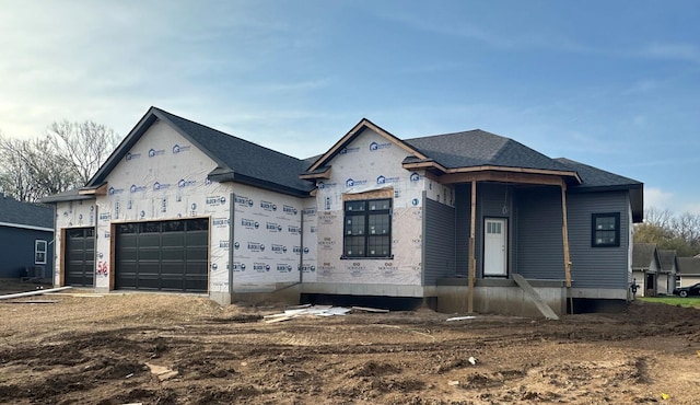 property in mid-construction with a garage and a shingled roof