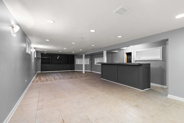 15058 Tripp Ave, Midlothian, IL 60445 - unfurnished living room with recessed lighting, baseboards, light tile patterned flooring, and bar area