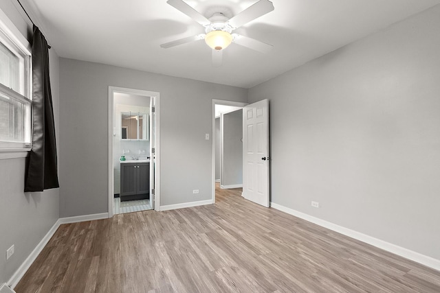 15058 Tripp Ave, Midlothian, IL 60445 - unfurnished bedroom featuring light wood-style flooring, baseboards, ceiling fan, and ensuite bathroom