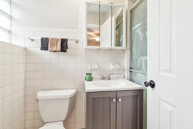 15058 Tripp Ave, Midlothian, IL 60445 - bathroom with toilet, vanity, and tile walls
