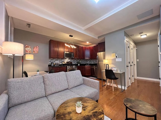 living room featuring wood finished floors and baseboards