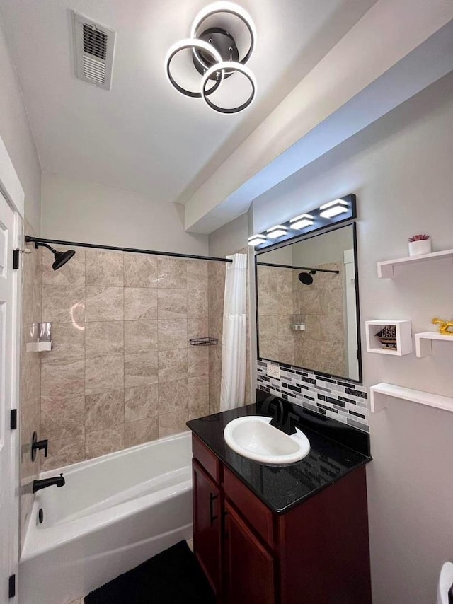 full bathroom with visible vents, shower / bath combination with curtain, backsplash, and vanity