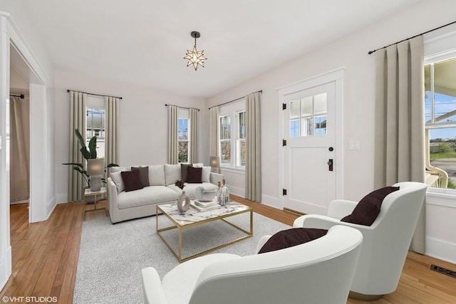 living room with a healthy amount of sunlight and light wood-style flooring