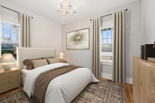 bedroom featuring baseboards, a chandelier, and wood finished floors