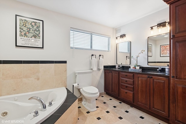 bathroom featuring double vanity, toilet, a tub with jets, tile patterned floors, and a sink