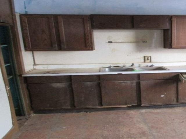 1207 S Main St, Paris, IL 61944 - kitchen with light countertops, dark brown cabinets, and a sink
