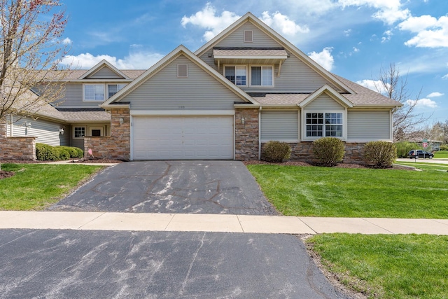 1103 Shingle Oak Ln Unit 3A, Rockford, IL 61107 - craftsman-style house with aphalt driveway, stone siding, roof with shingles, a front yard, and a garage